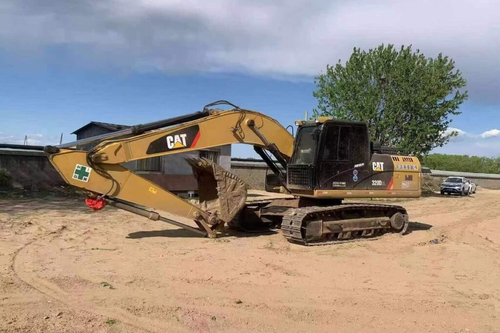 Used CAT 320D2L excavator side view in equipment yard