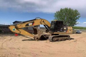 Used CAT 320D2L excavator side view in equipment yard