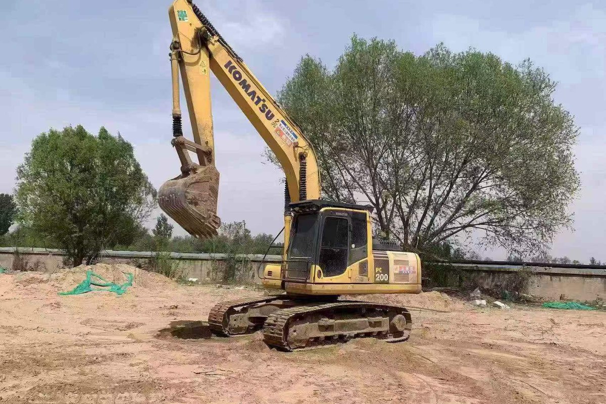 Used Komatsu PC200 class excavator in working position