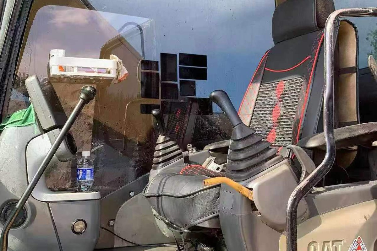 Used excavator cab and control levers inspection photo