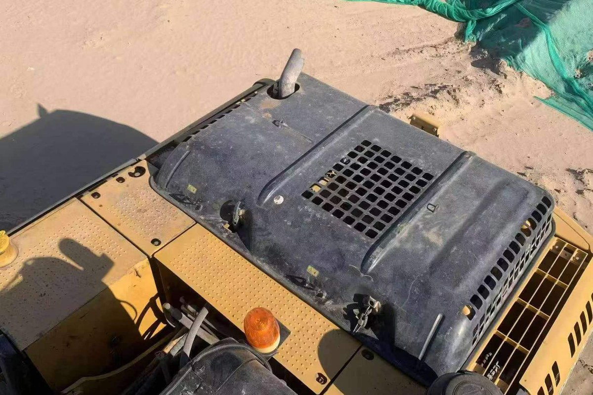 Used excavator engine cover and maintenance access photo