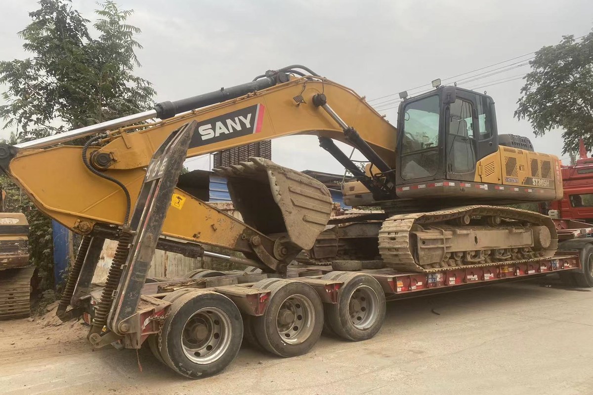 Used SANY excavator loaded on lowbed trailer for shipment