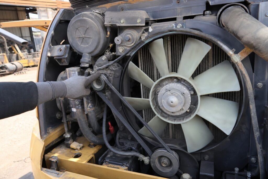 Excavator fan belt and cooling fan engine bay inspection