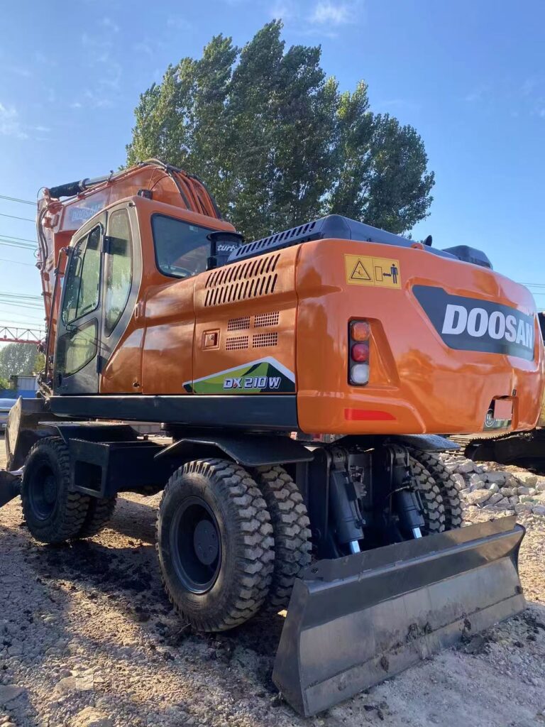 Rear view of the refurbished Doosan DX210W with wheeled undercarriage and blade